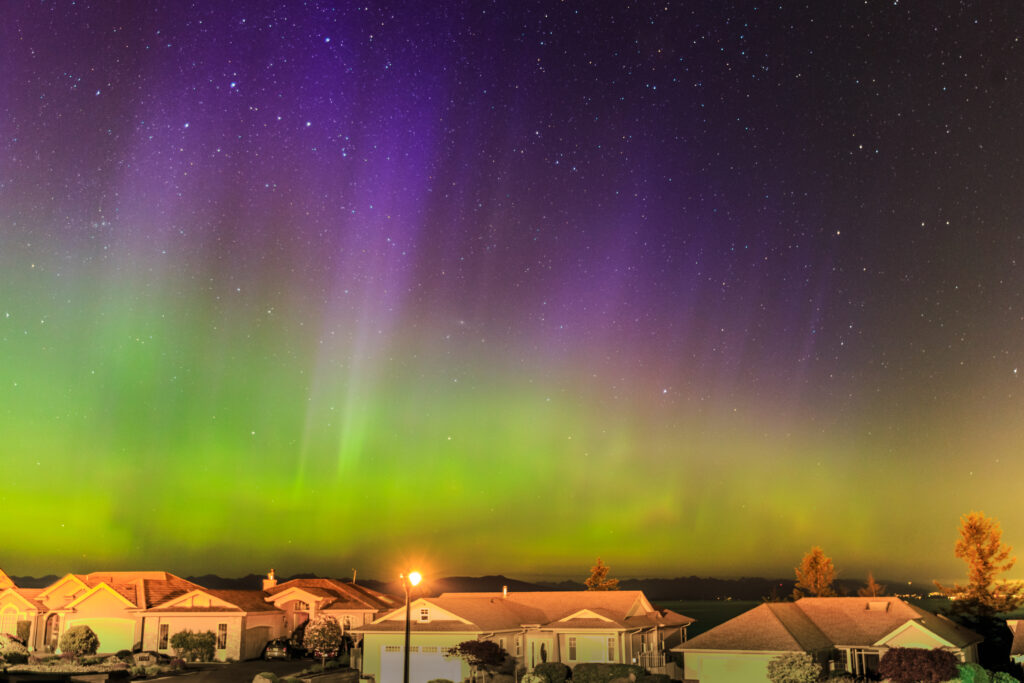City Lights. A bright aurora can be photographed even from urban locations. In southern Canada, the author was able to record this May 2017 display without venturing any farther than his front deck in Victoria, B.C. This 15-second exposure at ISO 1600, was used a Canon EOS 6D DSLR camera and a 16–35mm f/2.8 zoom lens set to 29mm and wide open.