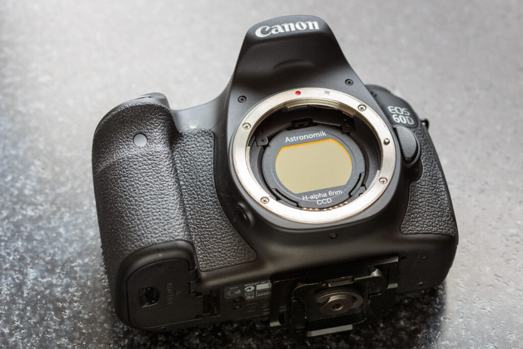 The author's camera is shown at left with the clip-in Astronomik H-alpha filter he used for the narrowband images presented in this article.