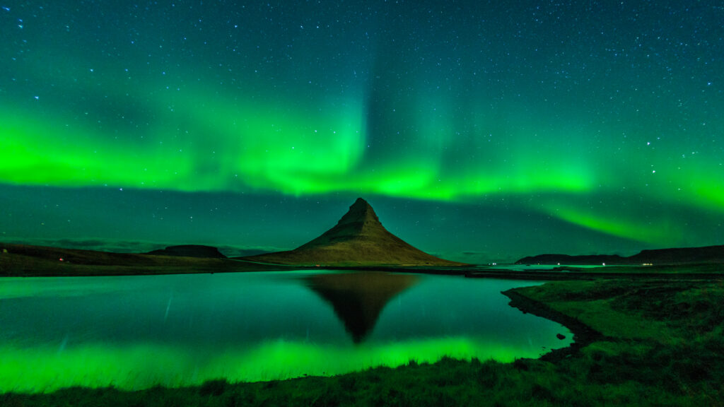 Kirkjufell Reflection. On a calm (but cold!) Icelandic evening, the author photographed the near-perfect reflection of Kirkjufell (Church Mountain) and a “ribbon” aurora. A Canon EOS 6D DSLR camera was used for this 13-second exposure at ISO 1600 with a Canon 15mm fish-eye lens fully open at f/2.8.